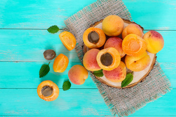 Wall Mural - A pile of ripe juicy apricots on a bright background. Top view.