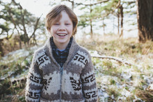 Happy Young Boy Smiling Outside In Winter