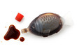 Open fish shaped take away soya sauce isolated on white from above. Spilled sauce.