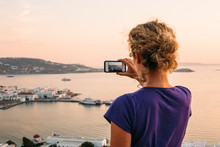Woman Photographing  With Smartphone At Sunset