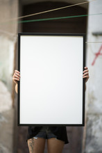 Girl Holds A Frame For A Poster Presentation
