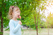 © mihakonceptcorn - Smiling little girl with a lollipop, free space. Beautiful girl with a lollipop.