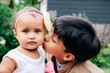 © Gabriel (Gabi) Bucataru/Stocksy - Older brother kissing baby sister