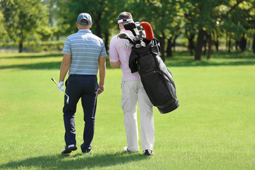 Poster - Young men on golf course in sunny day