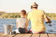 © Africa Studio - Dad and son fishing from pier on river