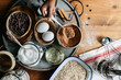 © Stocksy - Hand of a black girl placing two eggs in a tray with cookie ingredients