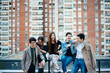 © Stocksy - Group of friends having fun on the rooftop