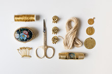 Golden Items Arranged On A White Background