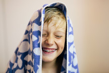 Laughing Boy With A Towel Over His Wet Hair