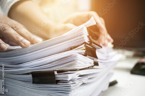 Cuadros en Lienzo Businessman working on stack reports papers files on desk work in office, busine