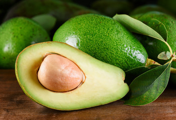 Canvas Print - Closeup view of fresh ripe green avocado on wooden table