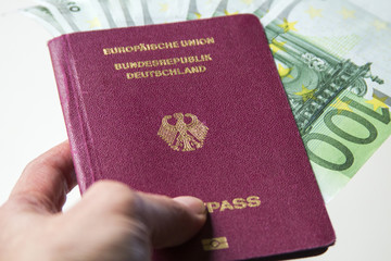 German international traveling passport and euro money.