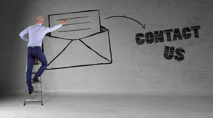 Wall Mural - Businessman drawing e-mail sketch on a wall 3D rendering