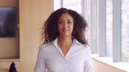 Wall Mural - Portrait Of Businesswoman In Office Walking Towards Camera 