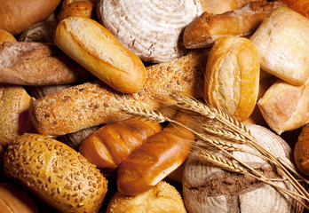 assortment of baked bread with wheat