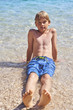 © Petr Bonek - Young child boy having fun in the sea on the waves and enjoying water in summer holiday