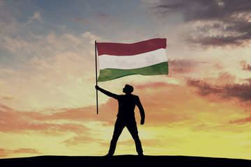 Wall Mural - Male silhouette figure waving Hungary flag. 3D Rendering