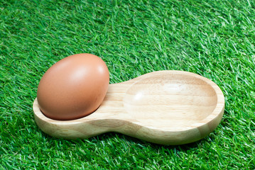 Eggs in wooden tray with lawn floor