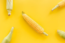 Corn On Cobs On Yellow Background Top View Copyspace