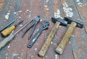 The carpenter's old tools on a wooden background