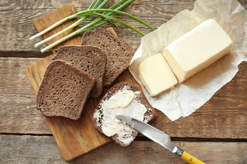 Poster - Cutting board with toasts and butter on wooden table