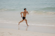 © F8  \ Suport Ukraine - Beach fitness man runner running training cardio. Healthy lifestyle male athlete doing exercise living an active life working out on sunset beach with ocean background topless in shorts.