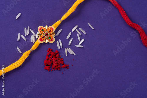 Fotografering Raksha Bandhan : Rakhi with rice grains and kumkum