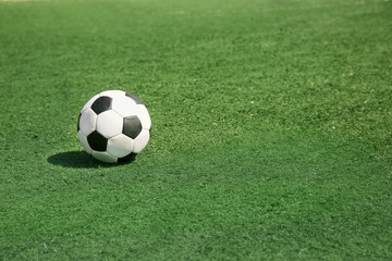 Canvas Print - Soccer ball on fresh green grass outdoors