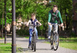 © Africa Studio - Dad and son riding bicycles outdoors