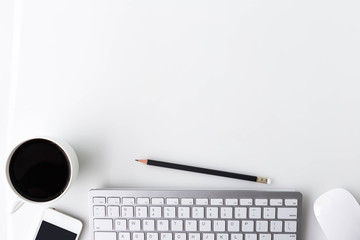 Modern white office desk top table with a cup of coffee, computer laptop, smartphone and other supplies. Top view with copy space on white background. Top view, flat lay.