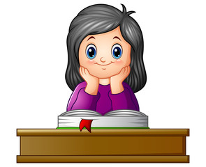 Wall Mural - School girl with textbook at desk