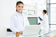 © Atstock Productions - Smiling Asian female pharmacist working in pharmacy