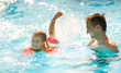 © Angelov - Little girl and happy father having fun in outdoors swimming pool
