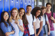 © Monkey Business - Teenage school kids smiling to camera in school corridor