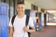 © Monkey Business - Happy mixed race teenage boy smiling in high school corridor