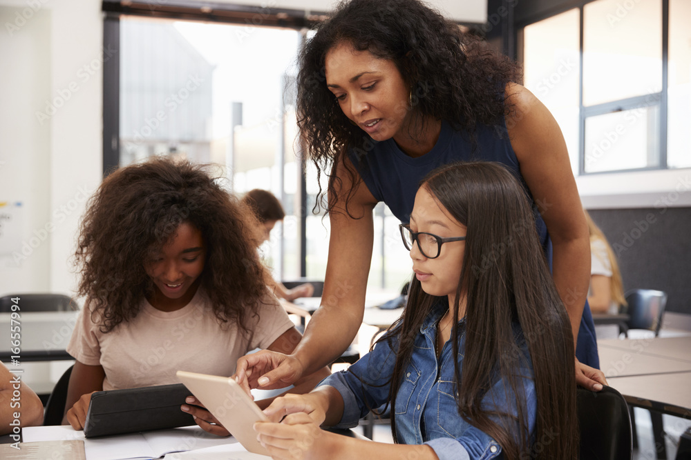 Teacher helping high school students with technology Stock Photo ...