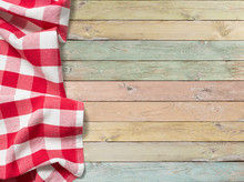 Red Checkered Picnic Tablecloth On Colorful Wood Table
