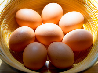 Chicken eggs in bamboo basket with beautiful window light.