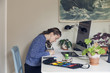 © Ulrika Kestere - Young woman drawing by her office desk