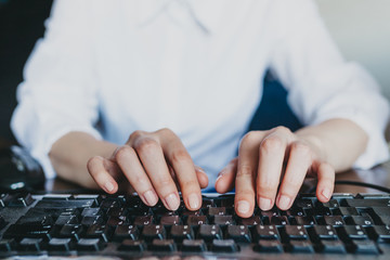 Wall Mural - Woman's hands typing on keyboard