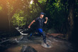 © Love You Stock - Trail runner athlete through waterfall with nature. concept of trail running with exercise for health.