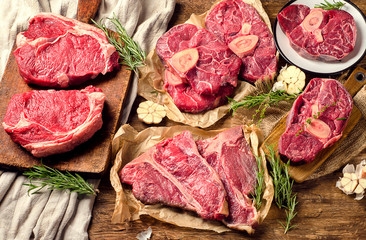 Raw beef meat on a dark wooden board.