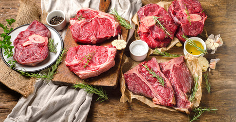 Raw beef meat on a dark wooden board.