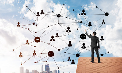 businessman on house roof presenting networking and connection concept. mixed media