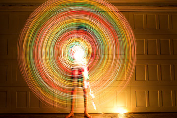 Boy spinning colorful lights