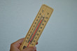 Mercury wooden thermometer shows very high temperature. Temperatures in Celsius and Fahrenheit degrees. Hot summer weather. Forty degrees over zero during the day.