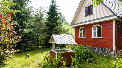 Poster - view of cottage and well from backyard in country