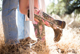 Fototapeta Desenie - Women and men in cowboy boots. Couple. Country style. Engagement photo. love story