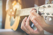 © Fluky - Men's hands are teaching women to play guitar.This image is blurred and Soft focus.