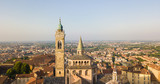 Fototapeta  - Bergamo, old city, drone aerial view of the Basilica of Santa Maria Maggiore. On the background the Padana plain